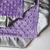 Corner detail of Satin trim purple blanket